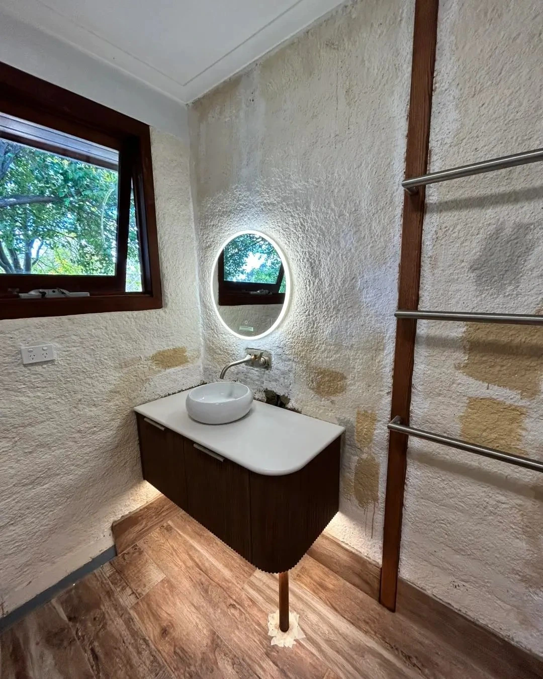 Vanity and mirror lighting in a renovated bathroom