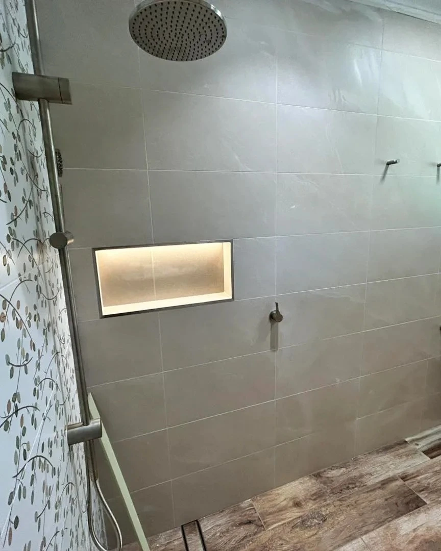 Strip lighting installed in a tiled shower niche